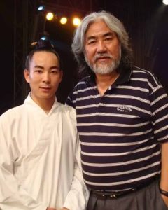 image shows Chinese director Zhang Jizhong with wudang master qingfengzi